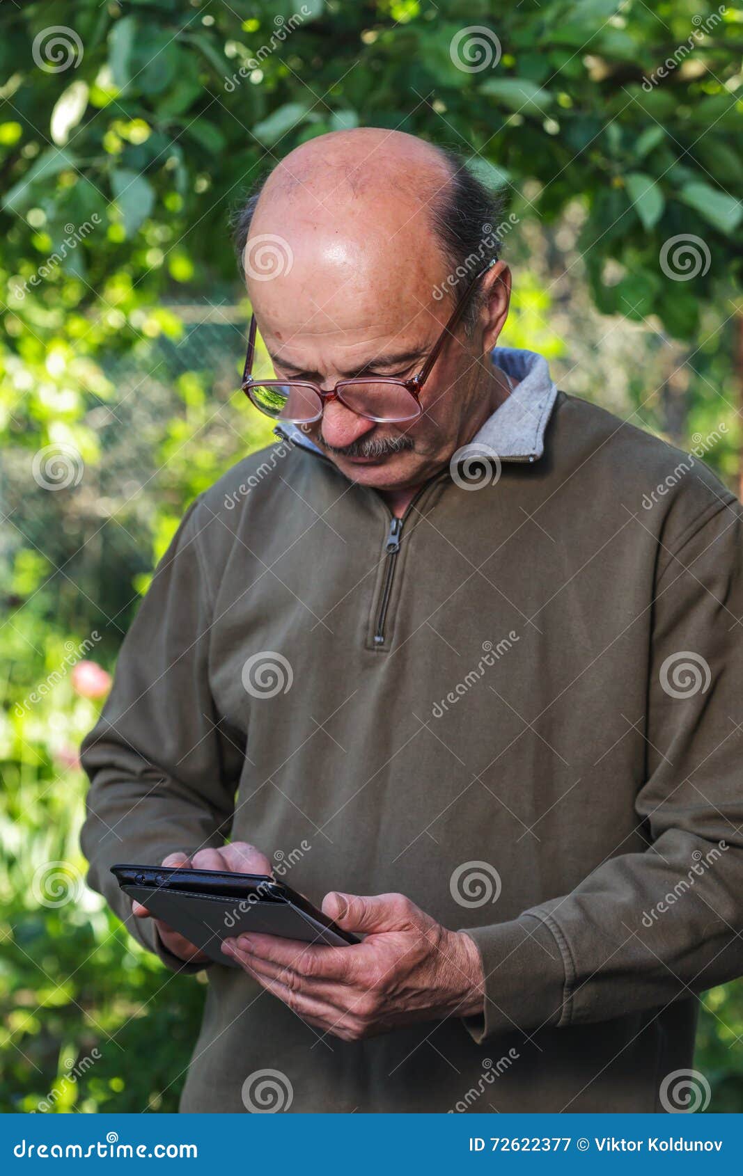 Elderly Man With A Bald Head Mustache And Glasses Learn To Deal With Tablet Stock Image