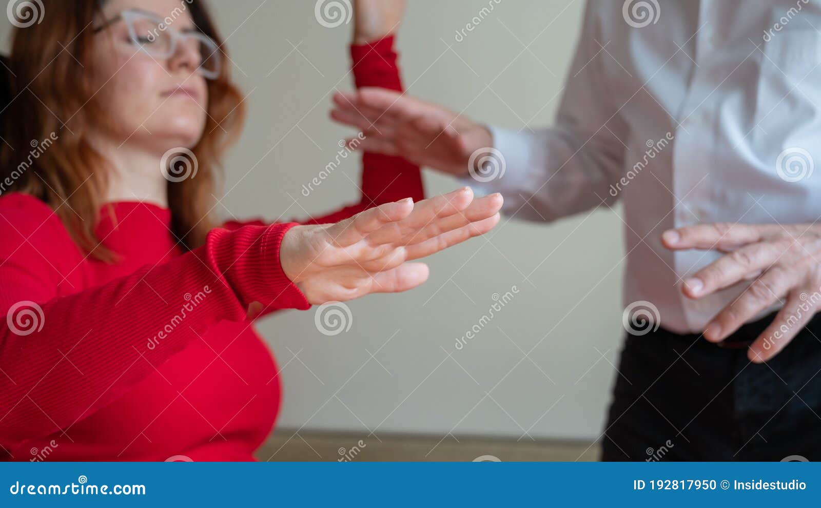an elderly man hypnotizes a female patient. a woman in a session with a male hypnotherapist during a session. therapist