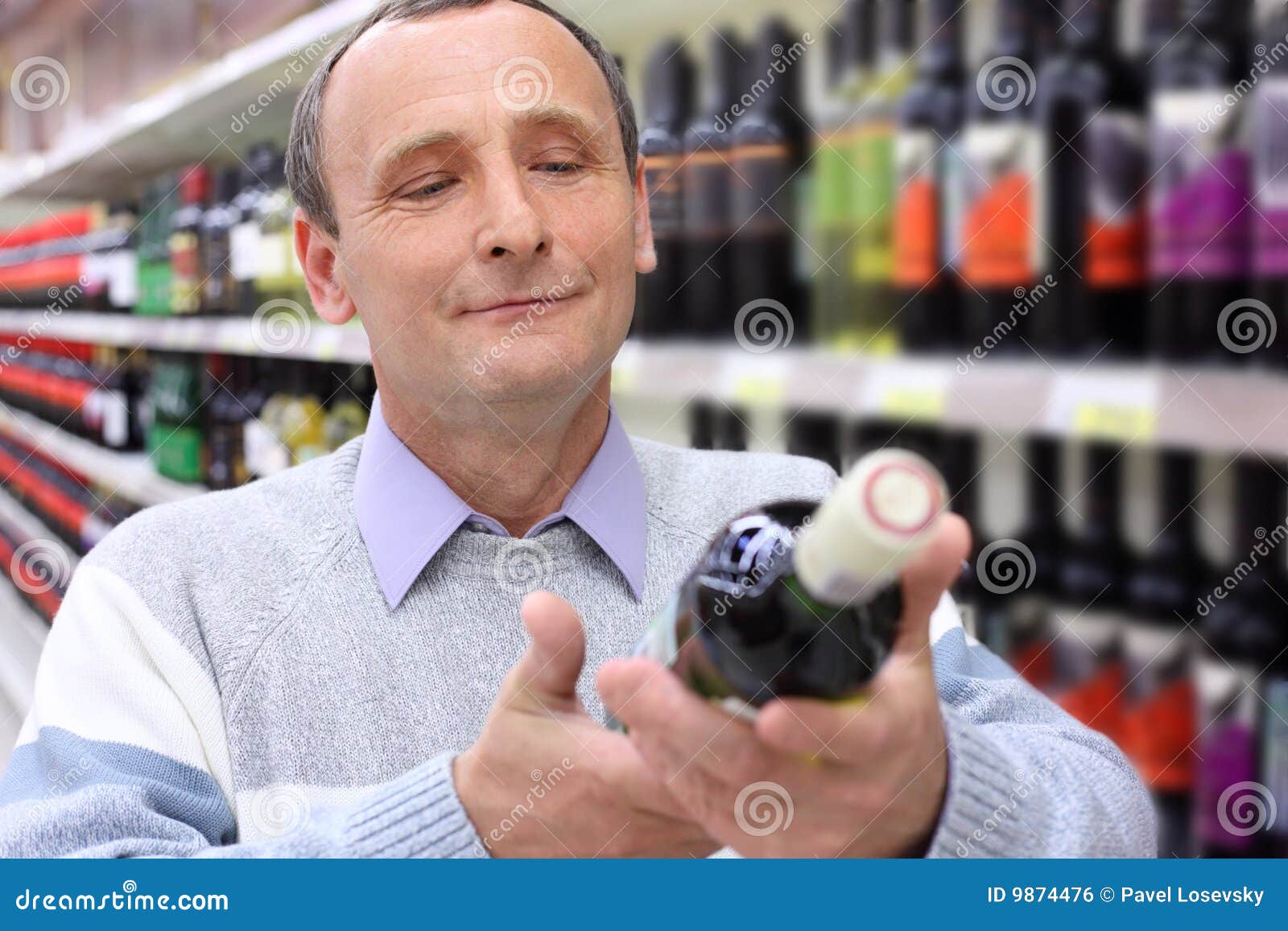 Elderly Man in Shop Looks on Wine Bottle Stock Photo Image of retail