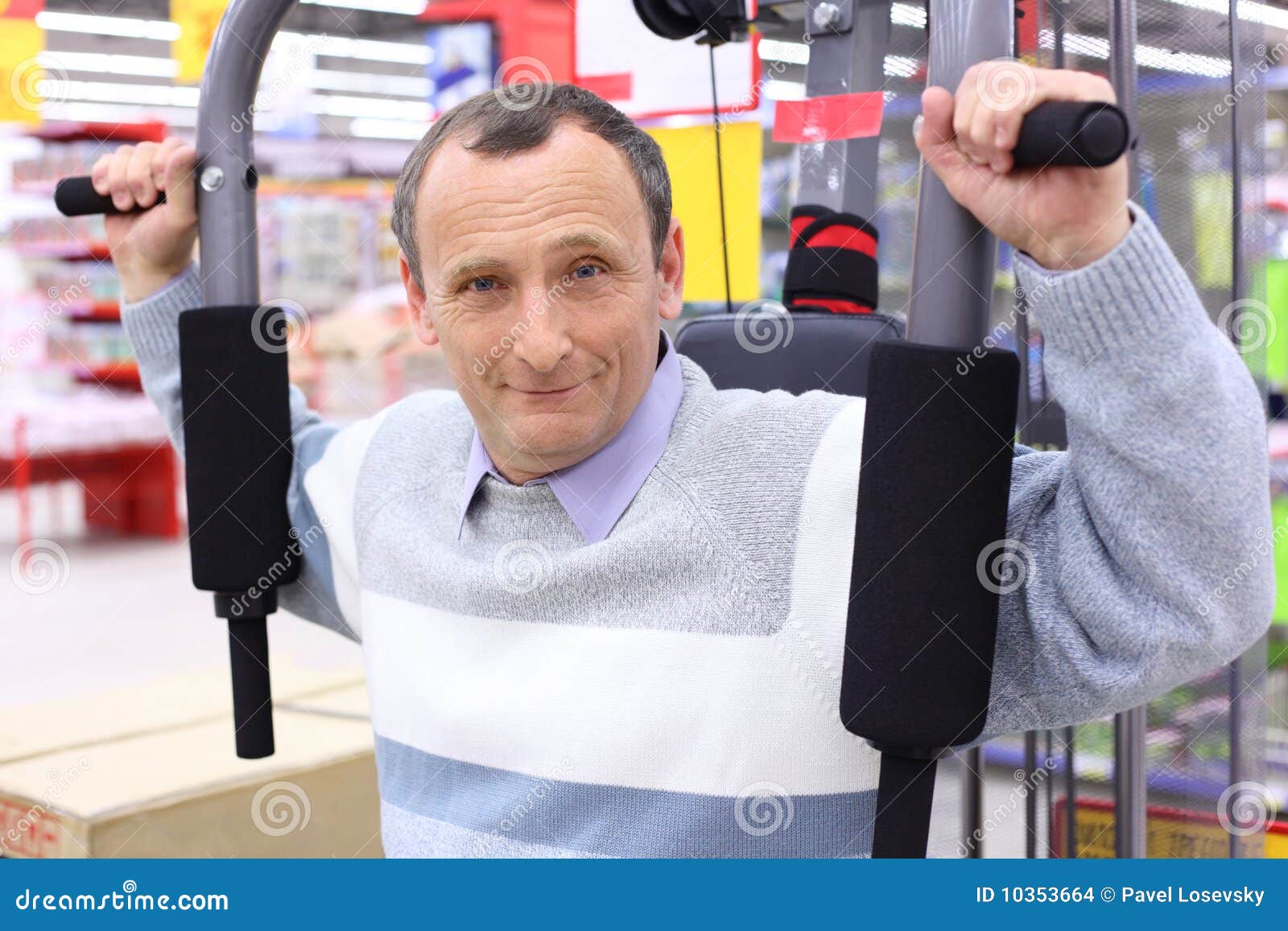 elderly man in shop on sports exerciser