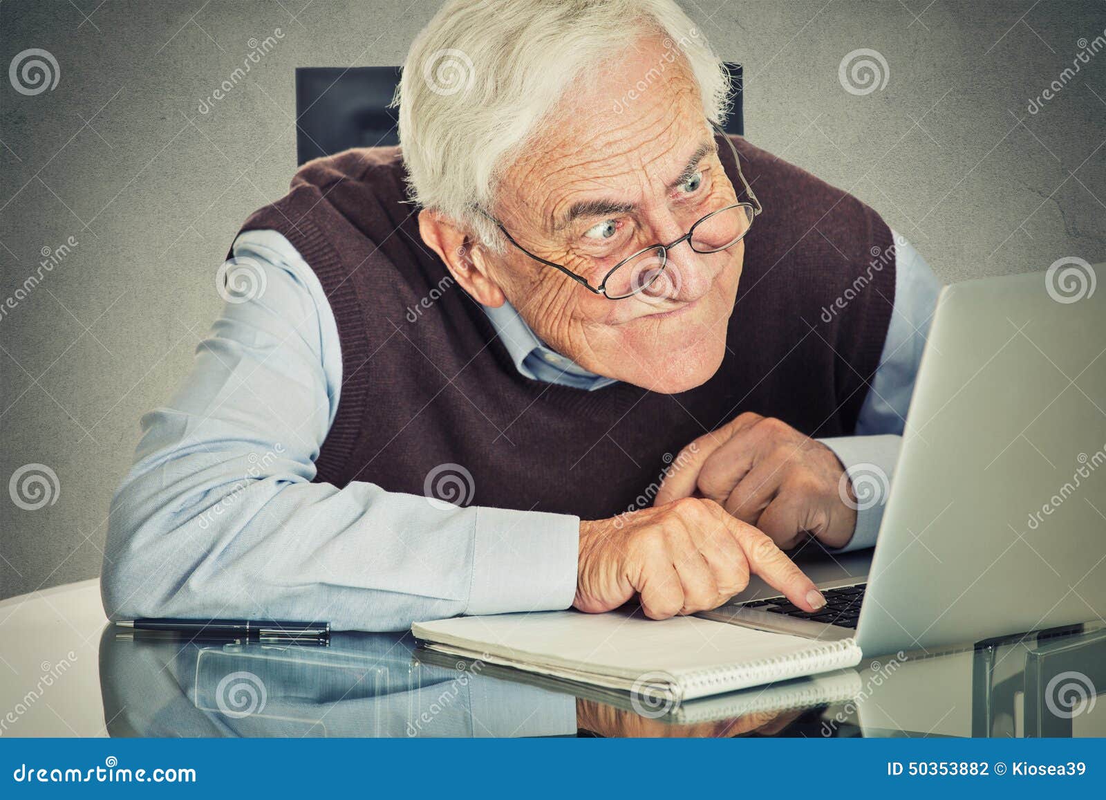 elderly old man using laptop computer sitting table isolated grey wall background senior people technology concept 50353882