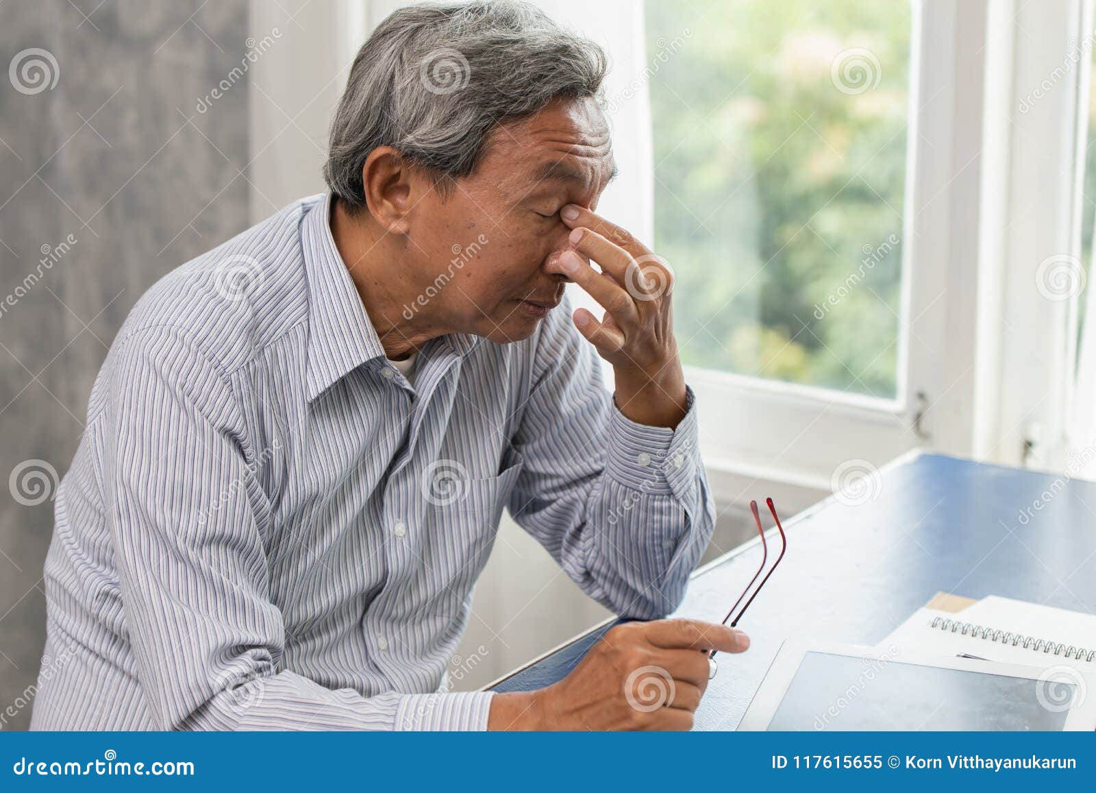 elderly stress tired and holding his nose suffer sinus pain fatigue