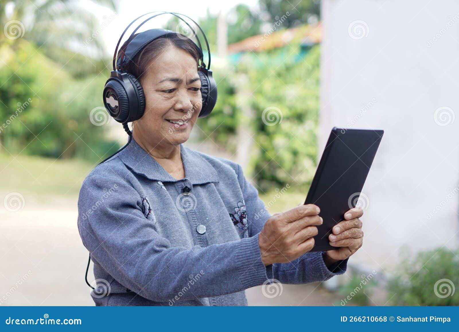 elderly use technology smart device. relax with online music