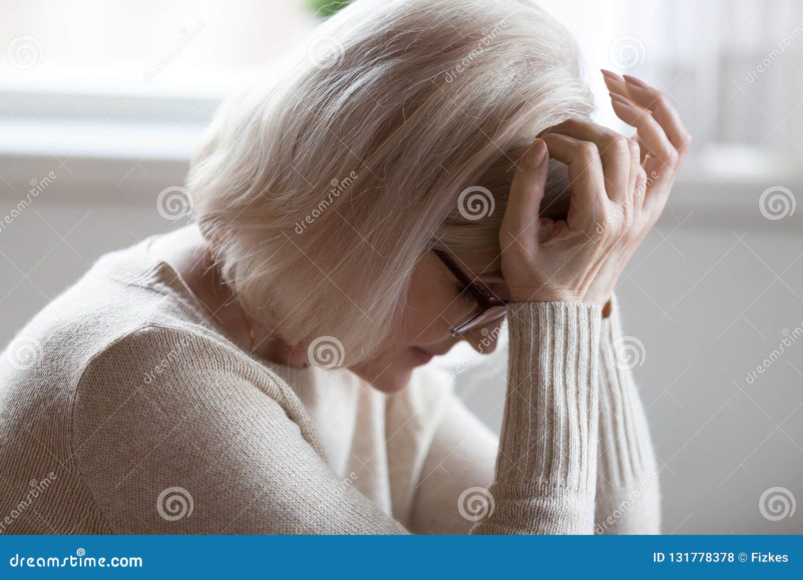elderly woman feeling unwell suffering from pain or dizziness