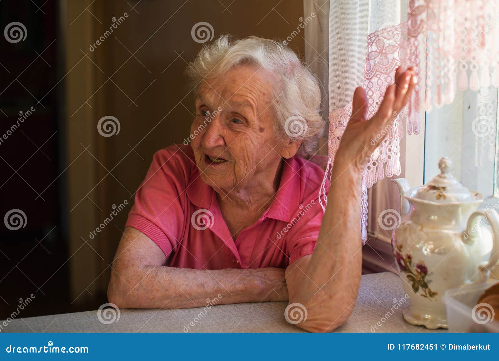 Elderly Happy Woman Sits at the Kitchen Table. Stock Image Image of