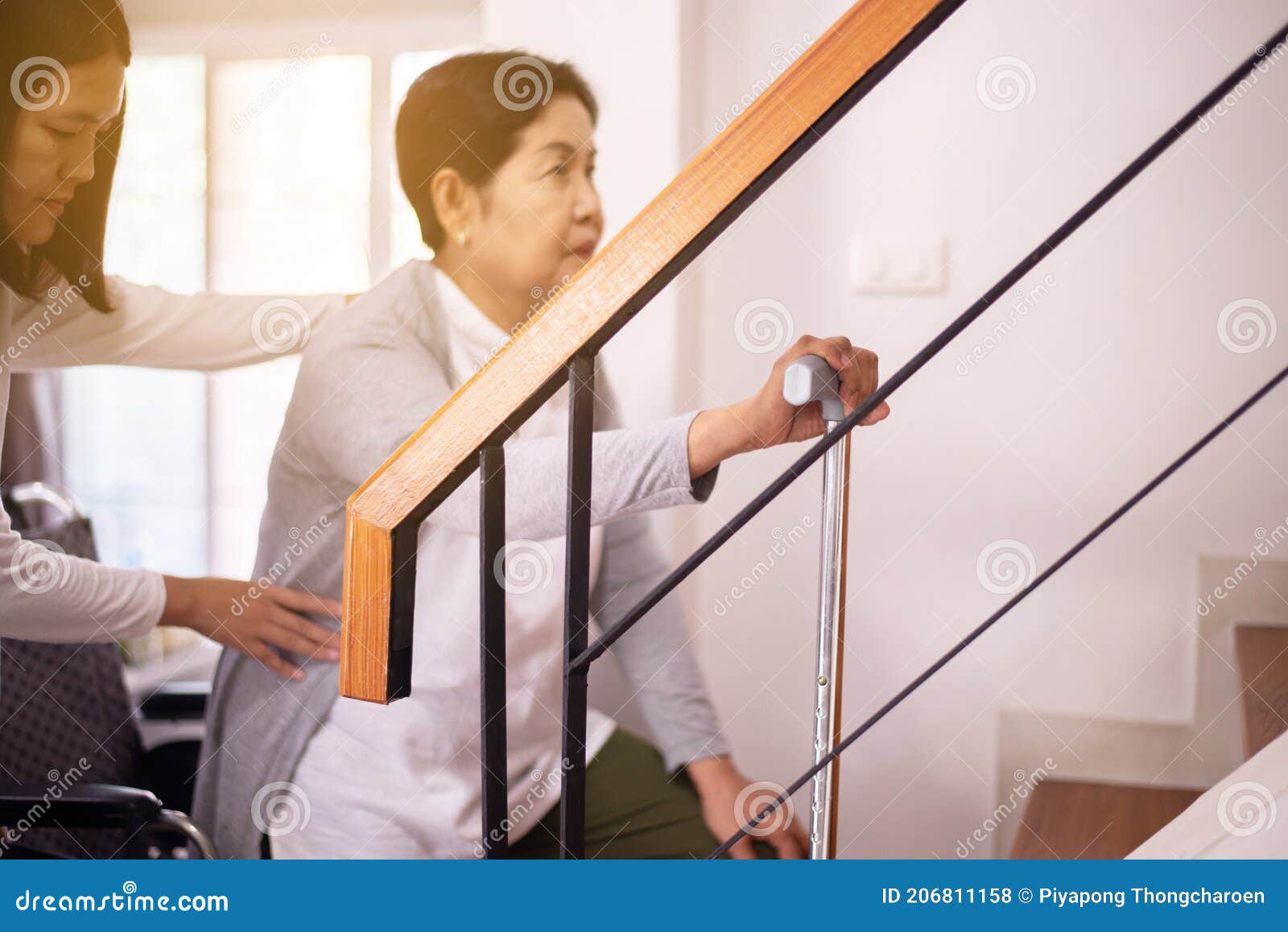 elderly woman hands holding sticks while walking up stair at home,caregiving take care and support,self-care for family caregivers