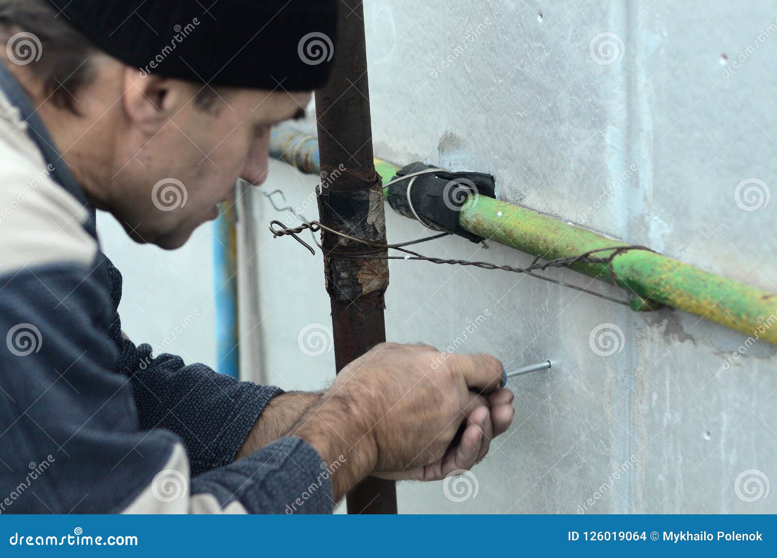 A Worker Creates A Form For Pouring Concrete Stock Image