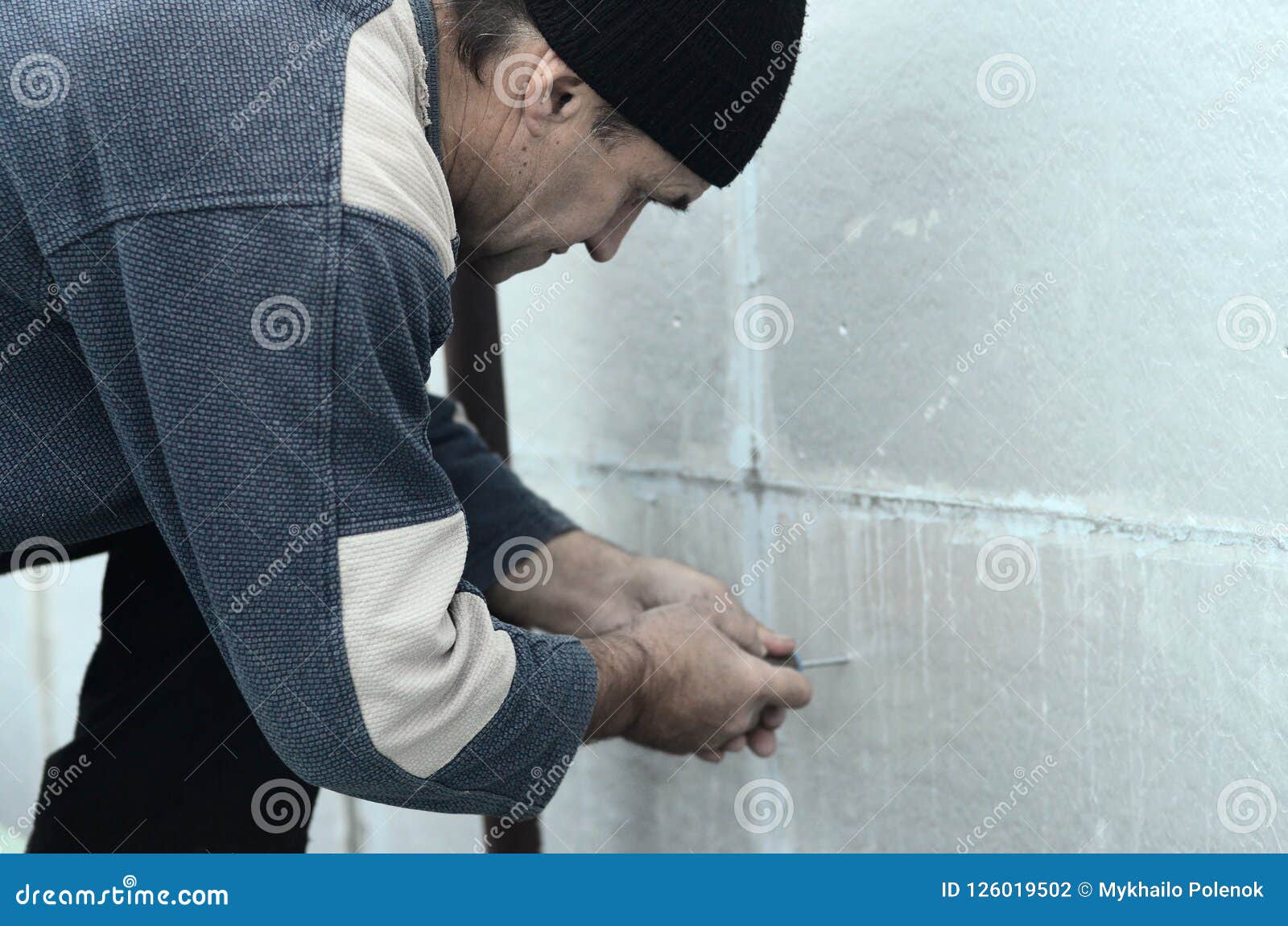 A Worker Creates A Form For Pouring Concrete Stock Image