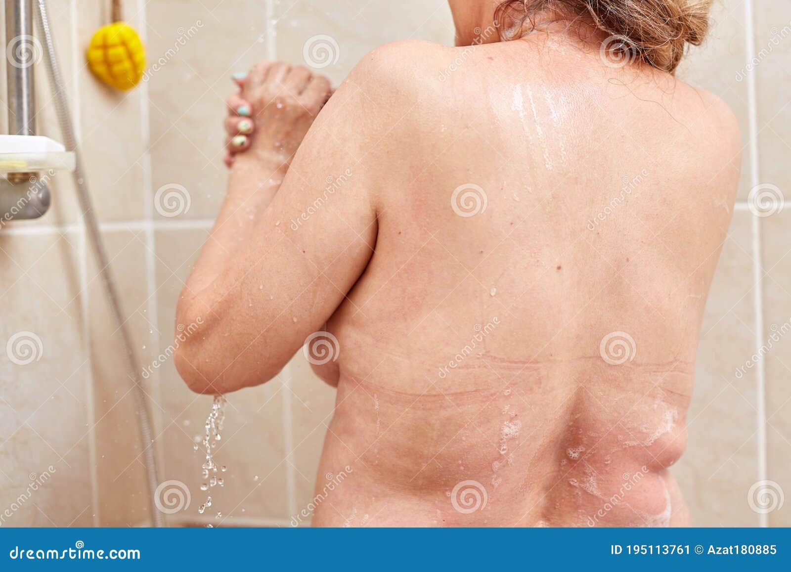Mature woman recording herself having fun while showering