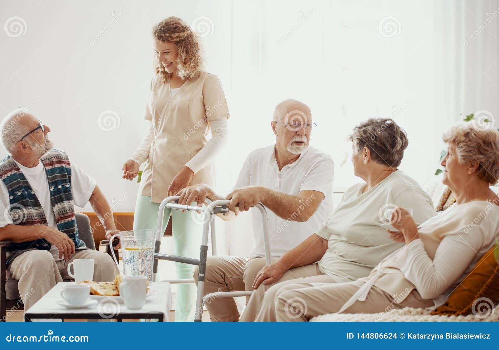 elders spending time in the common room of the care home