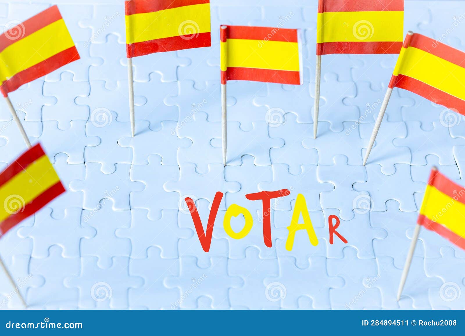 elections in spain, spanish flag concept and votar lettering meaning vote in english on white puzzle pieces