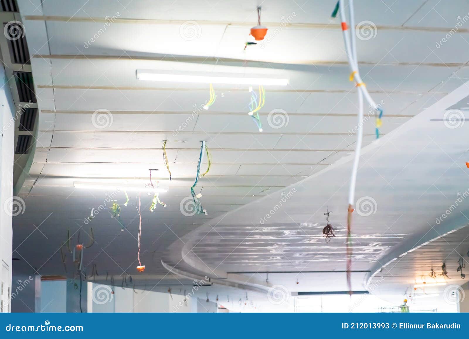 Electric Cables Hanging from Ceiling in a Construction Site. Work in