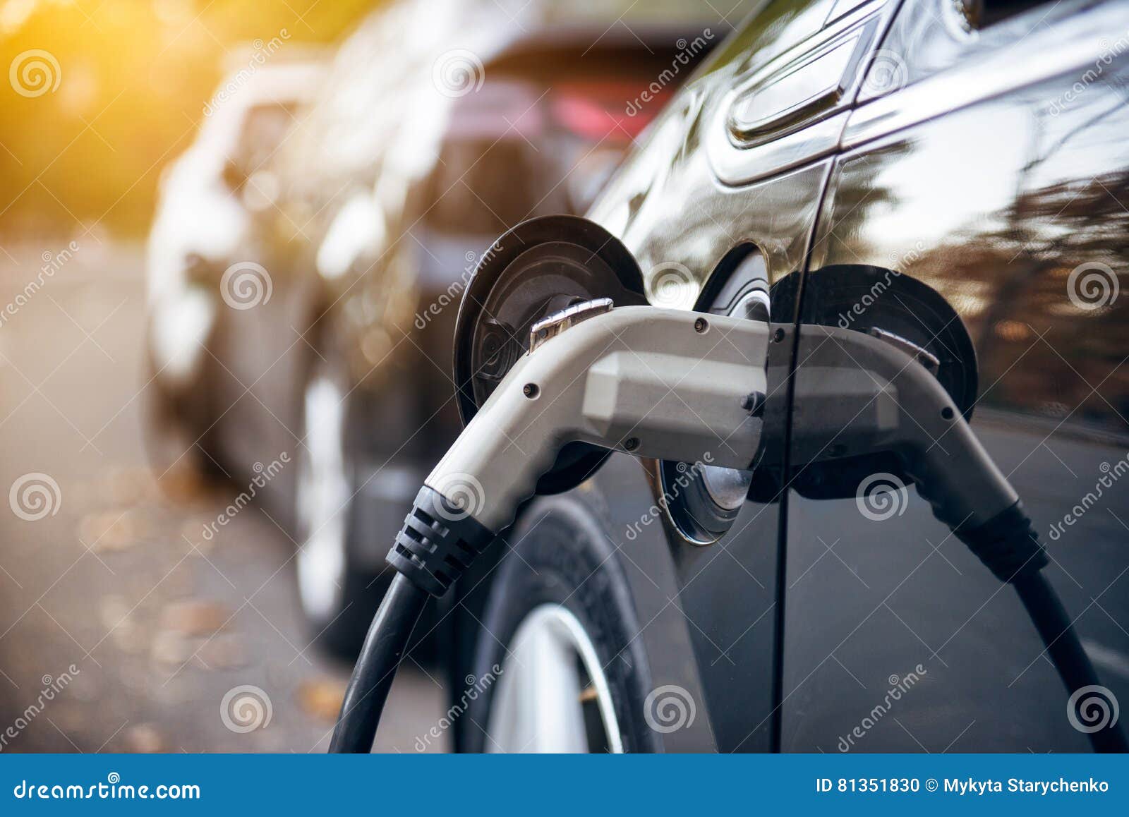 Electric Car Charging on Parking Lot with Electric Car Charging Station