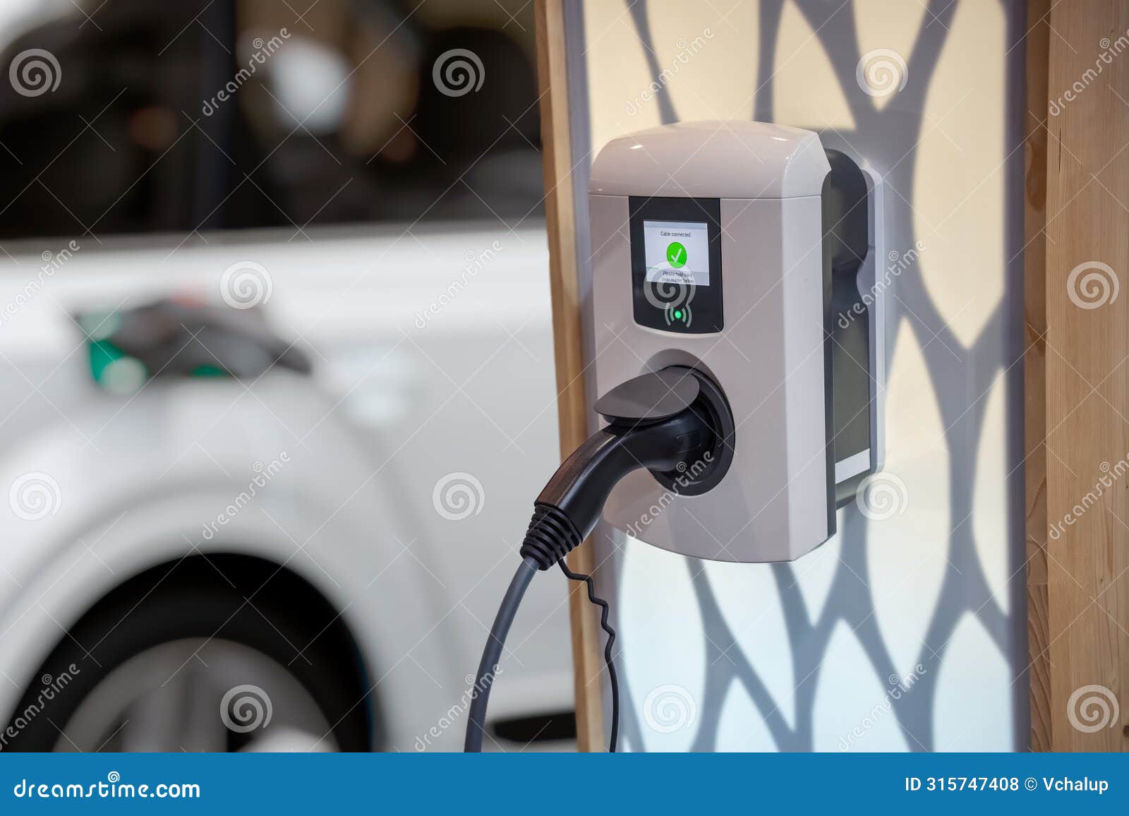 electric car (ev) is charging in socket with cable