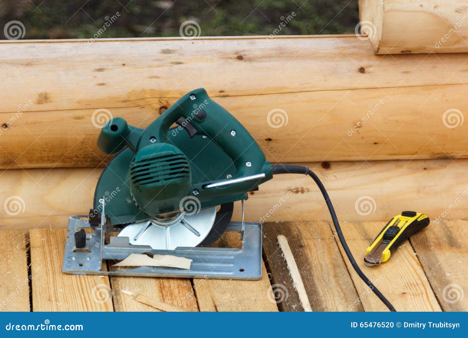 Electric Circular Saw and Knife on a Wooden Platform Stock Photo