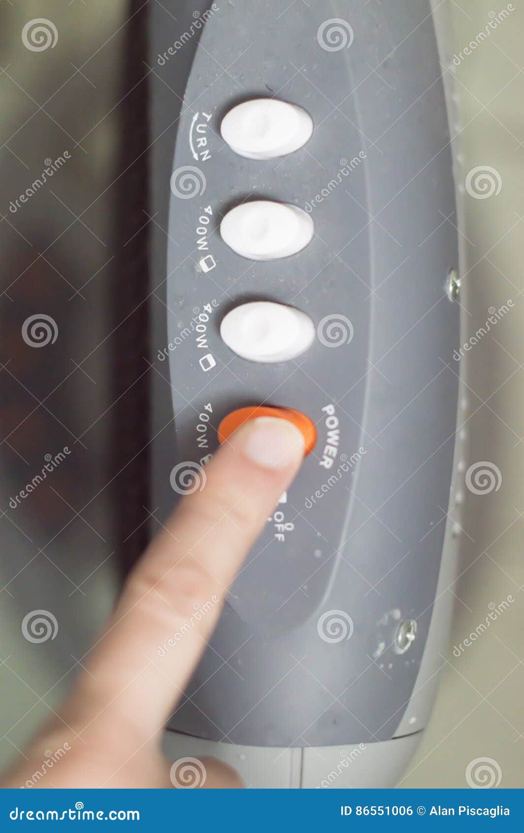 Man Setting The Power Setting On An Electric Oven Grill By Turning A