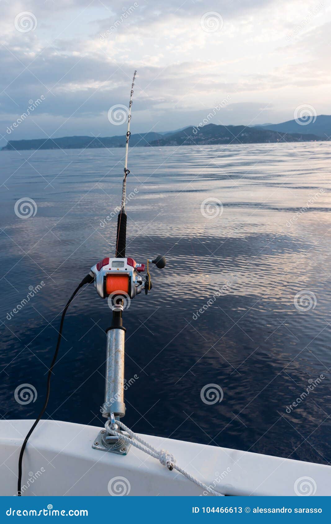 Electric Fishing Reel Mounted on a Rod with Sea in the Background and  Orange Line Stock Image - Image of fishhook, hobby: 104466613