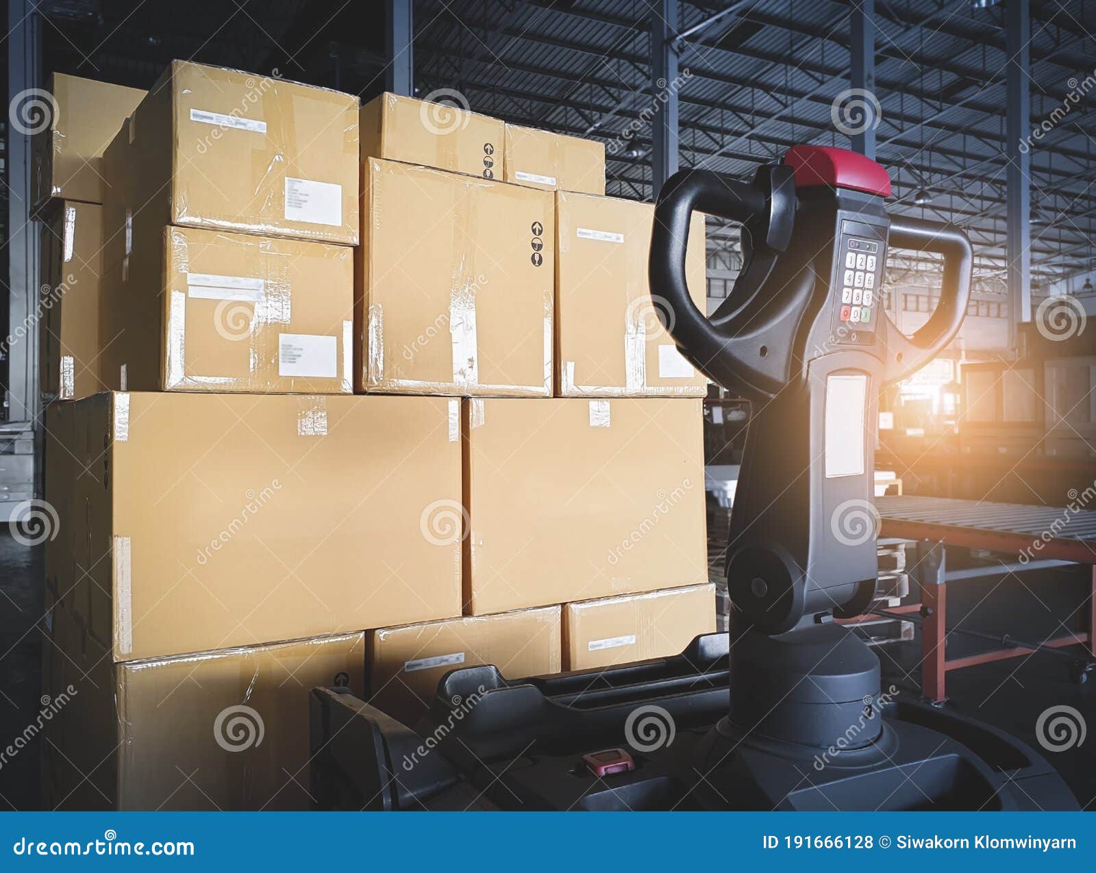 Stack Of Shipment Package Boxes On Wooden Pallets And Hand Pallet Truck In Interior Warehouse