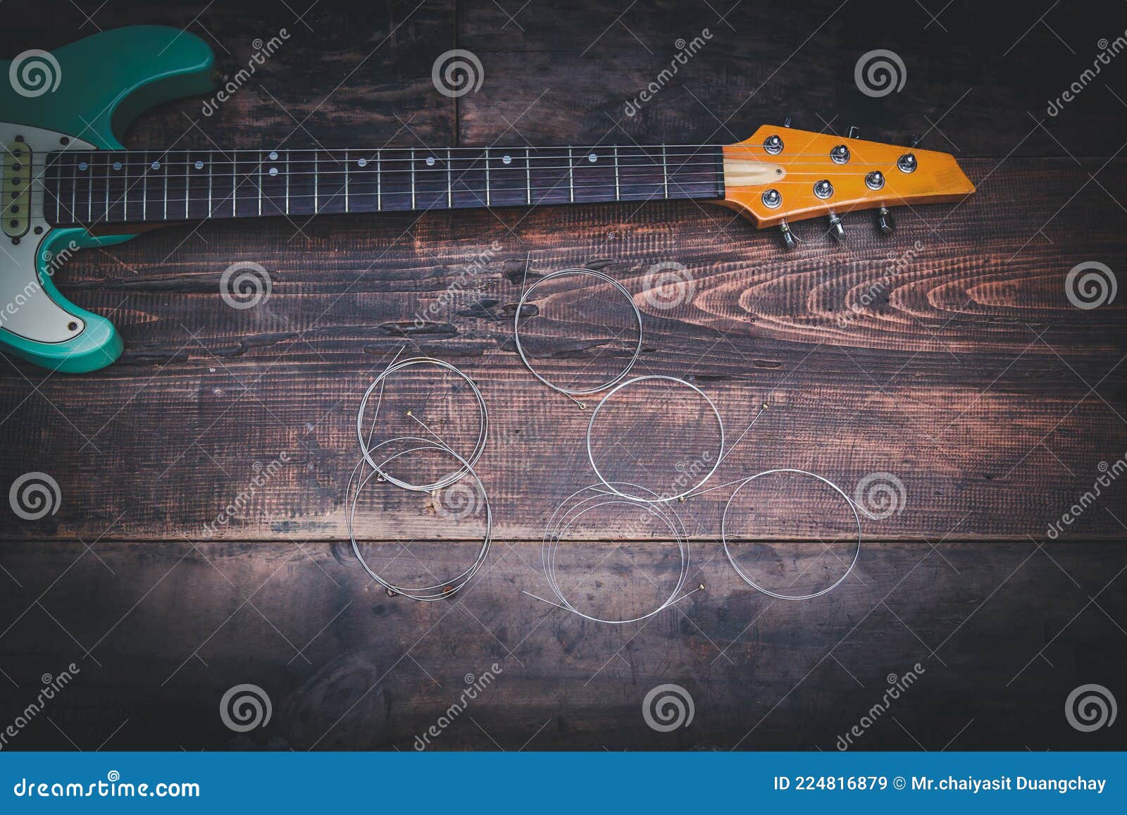 electric gritar and guitar strings on old vintage wood floor