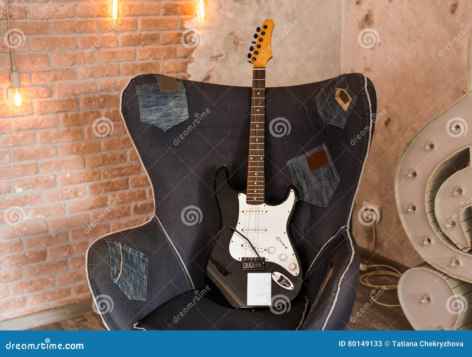 Electric guitar on a chair stock image. Image of design 80149133
