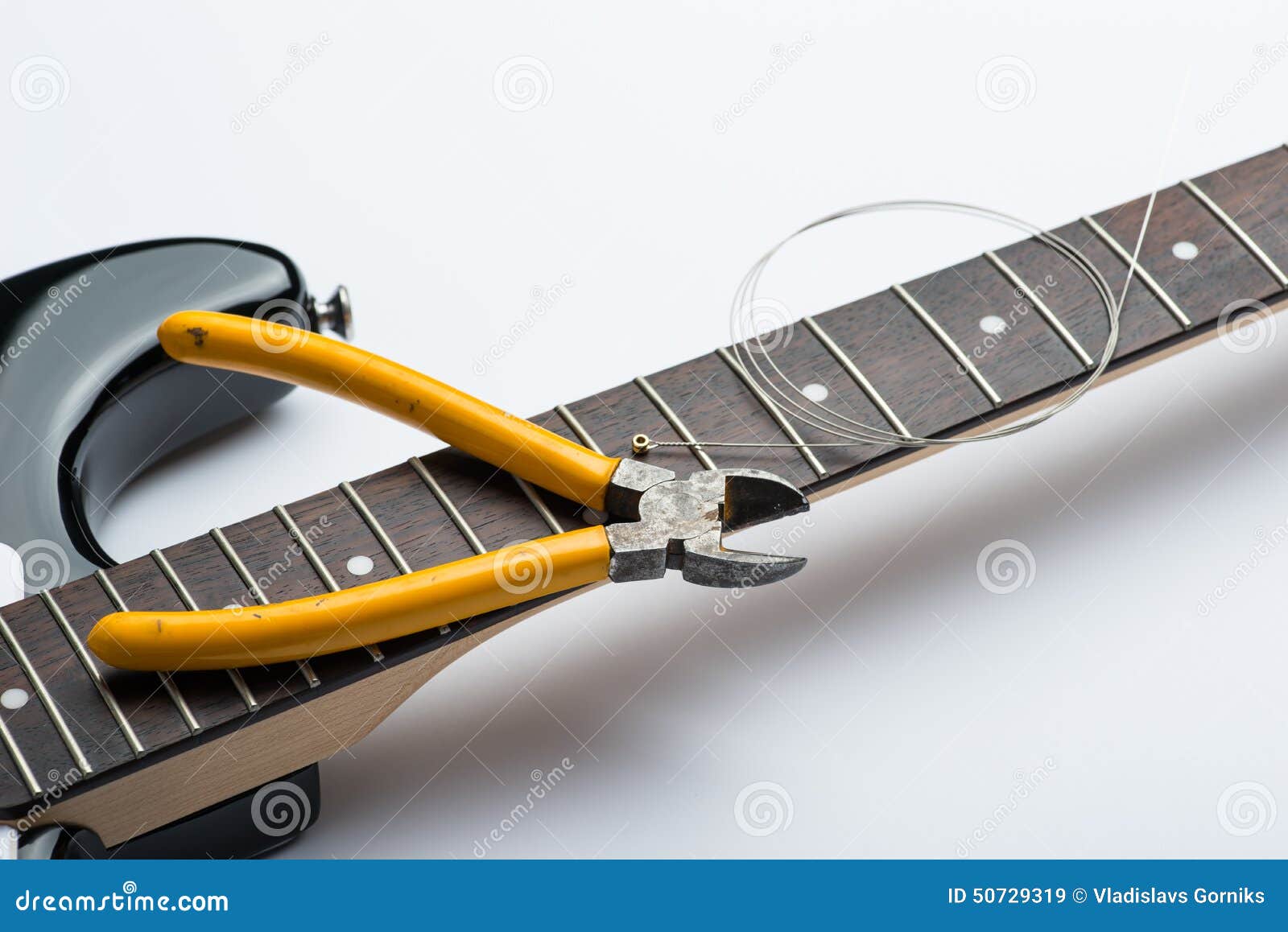 Electric Guitar Frets with String and Yellow Nippers Stock Image