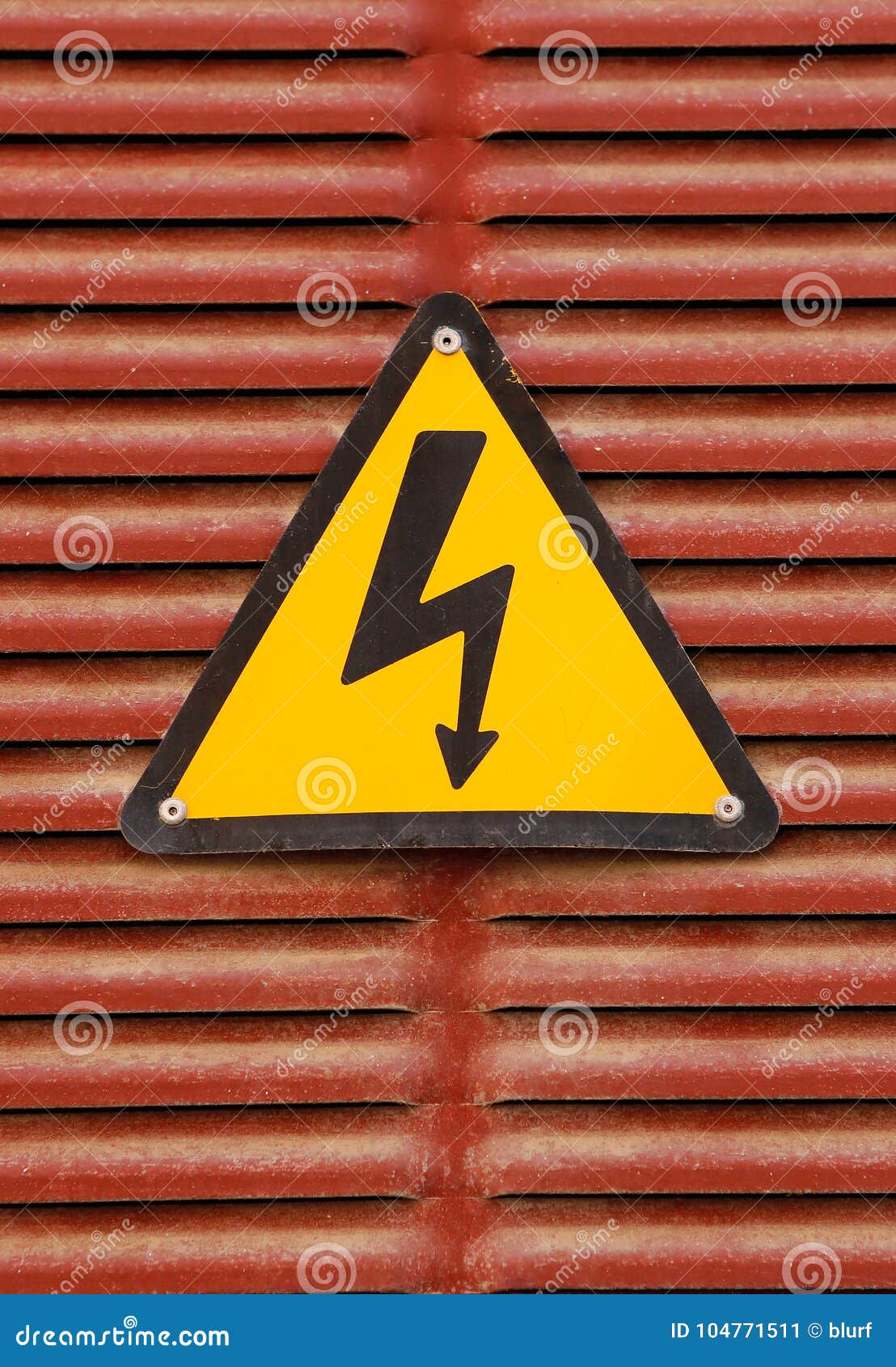 electric hazard advert sign on a red metal wall background