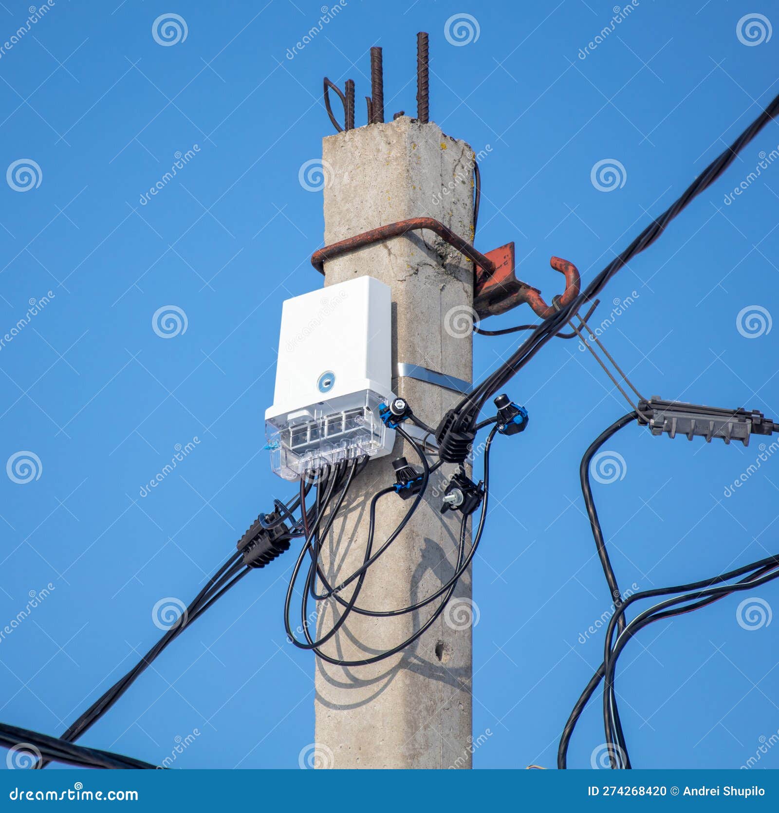 An Electric Meter on a Pole Against a Blue Sky Stock Photo Image of