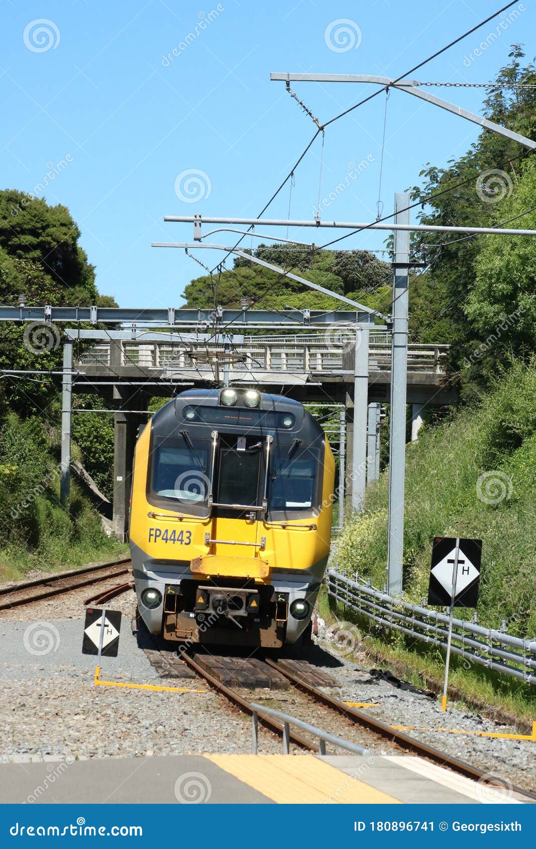 Electric Passenger Train Arriving Pukerua Bay, NZ Editorial Photo