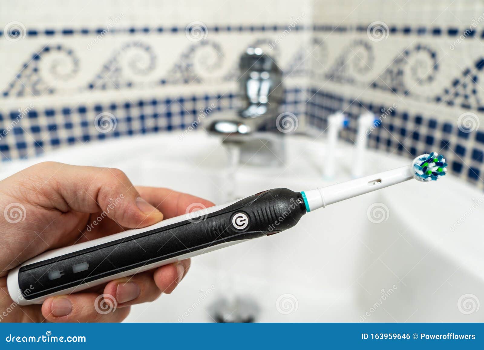 Electric Rechargeable Toothbrush with a Black Handle and Toothbrush