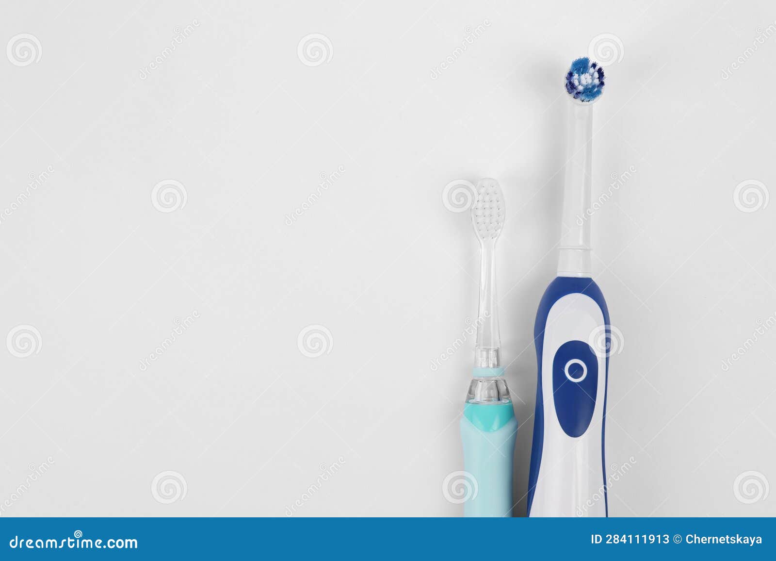 Electric Toothbrushes on White Background, Flat Lay. Space for Text