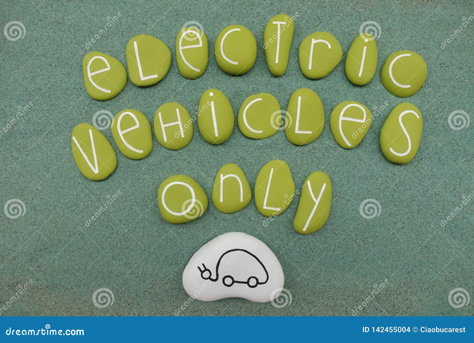 electric vehicles only text with green colored stones over green sand