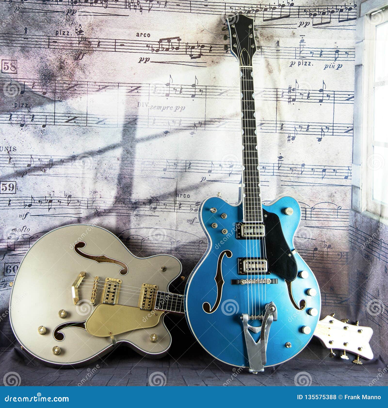 Electric Vintage Guitars Against a Musical Backdrop Stock Photo Image