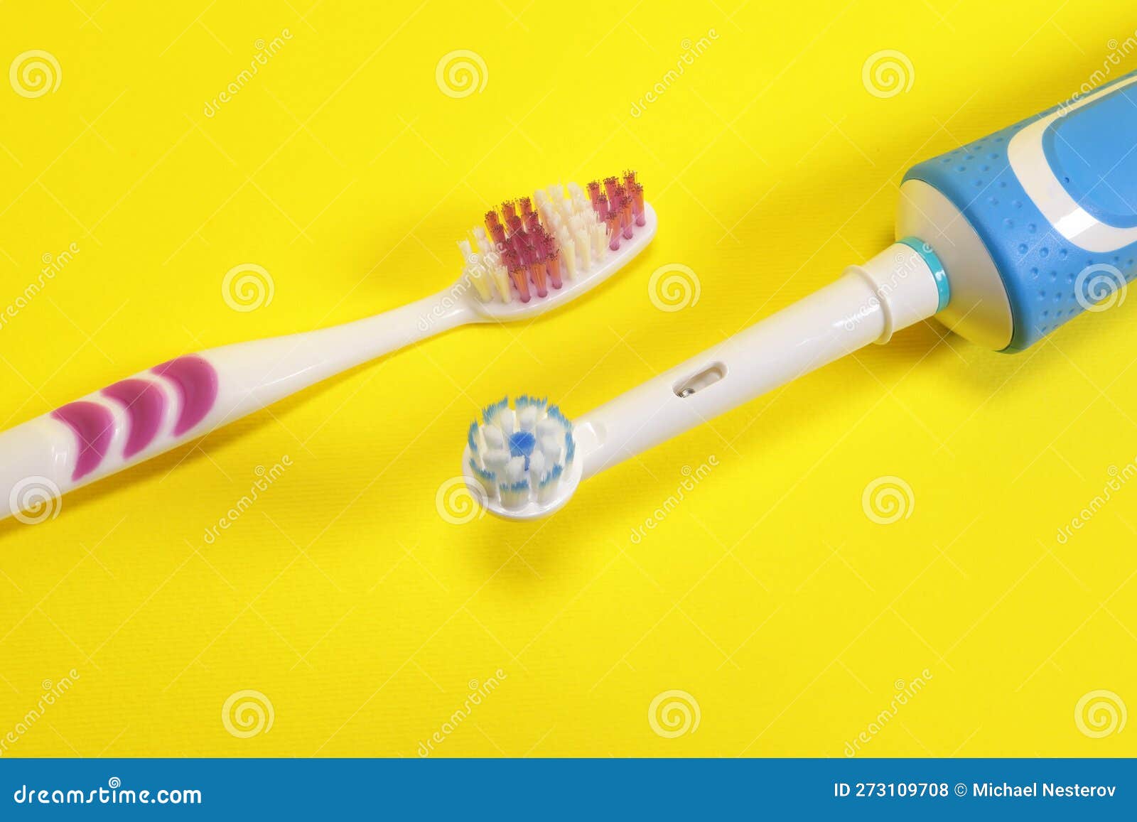 Electric Vs Manual Toothbrushes on Yellow Background Stock Photo