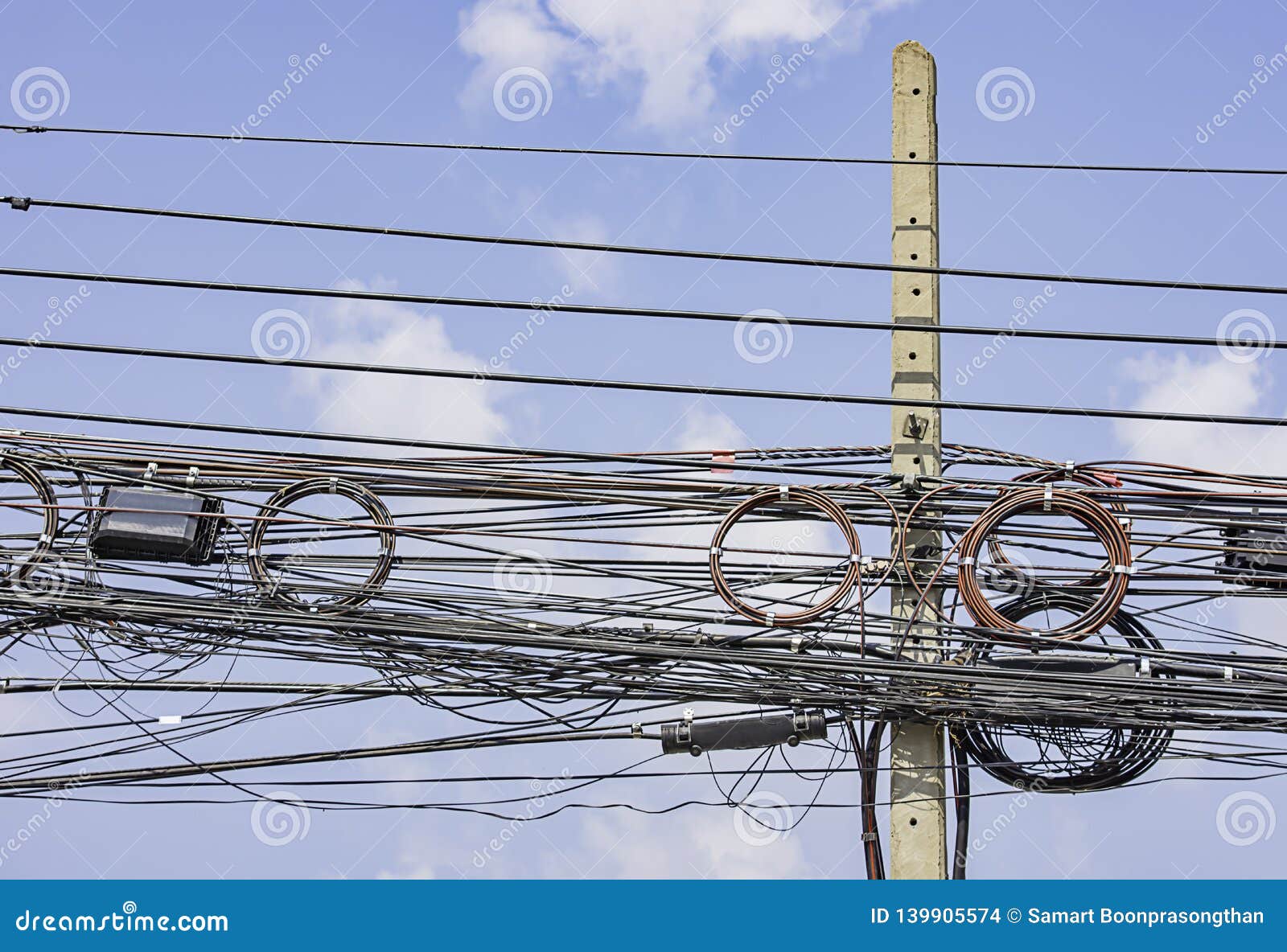 Electric Wires and Cables Hanging on a Concrete Pillar and the Bright