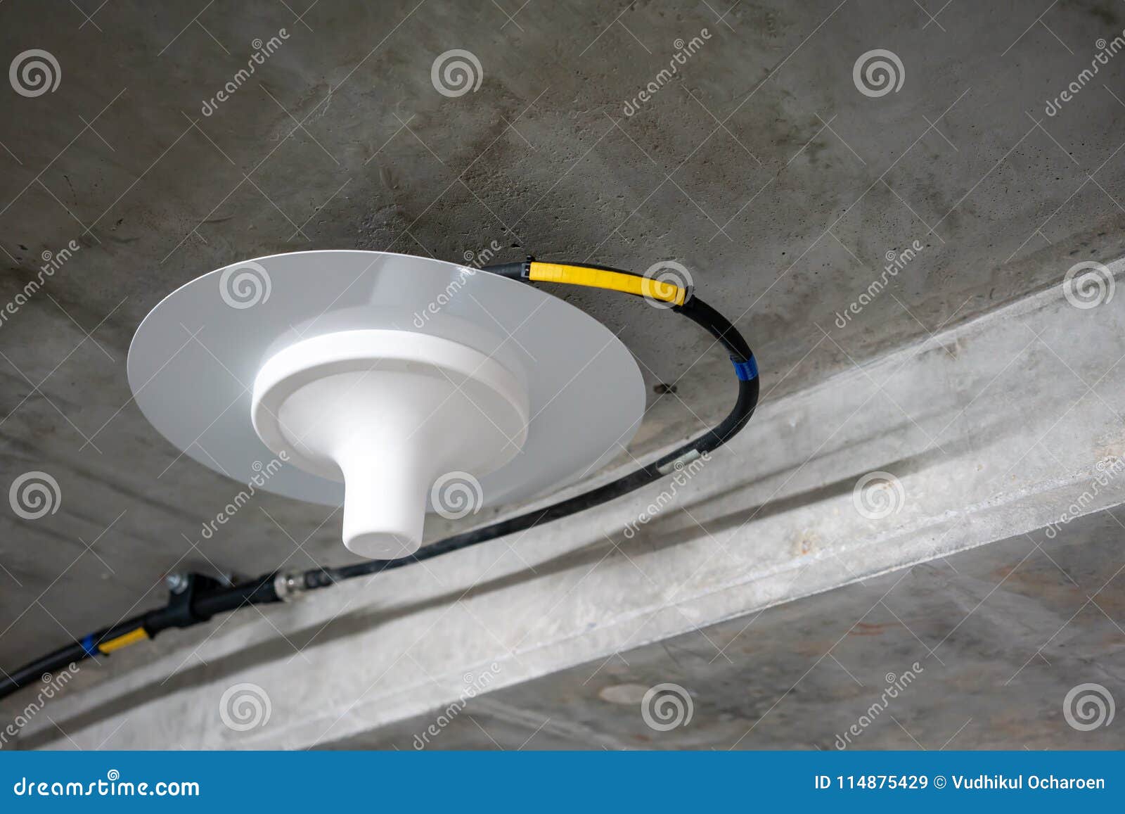 Electric Wires Running Along The Concrete Ceiling Under Neon