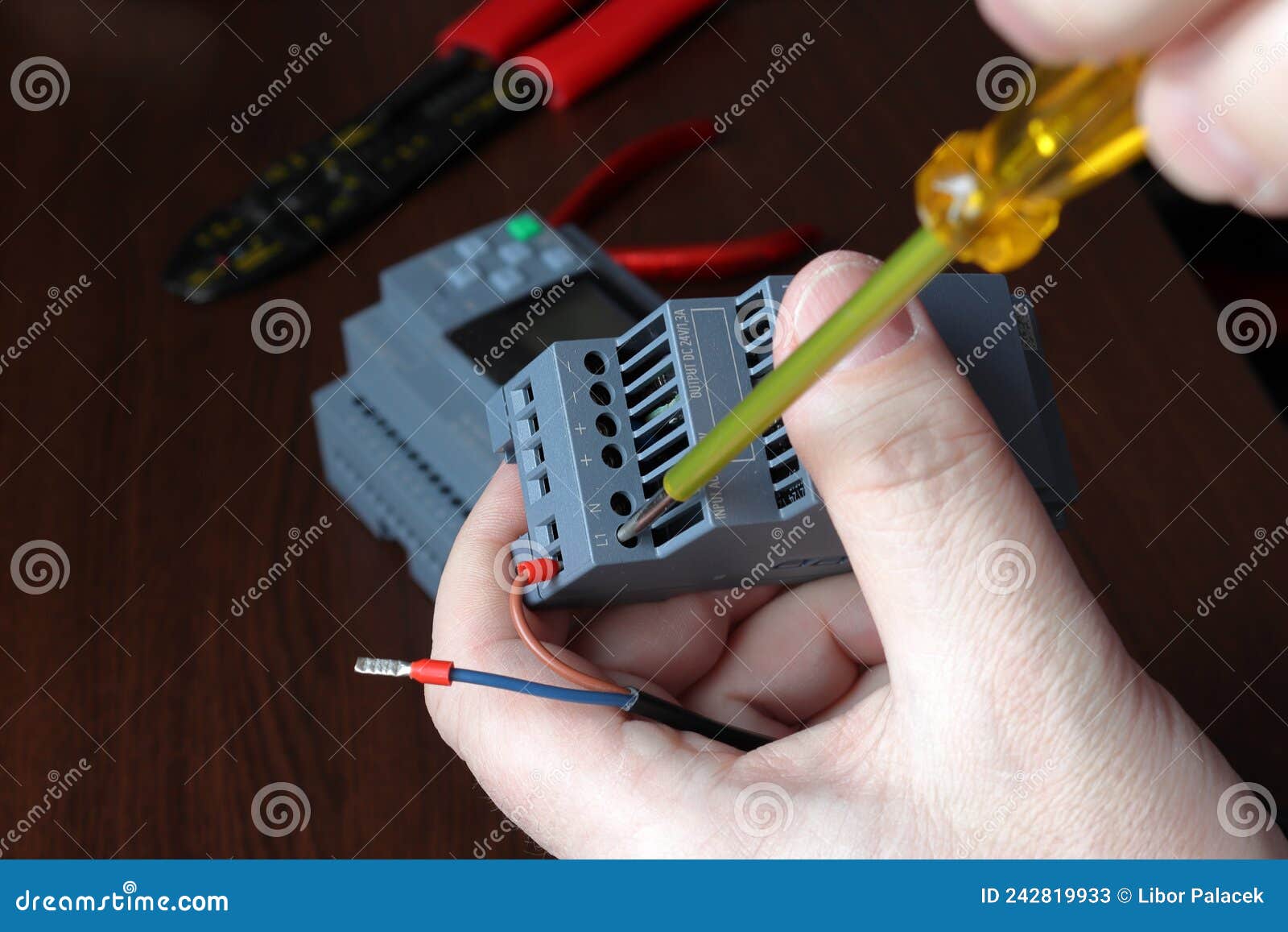 The Electrical Engineer Connects the Power Cable To the Power Supply