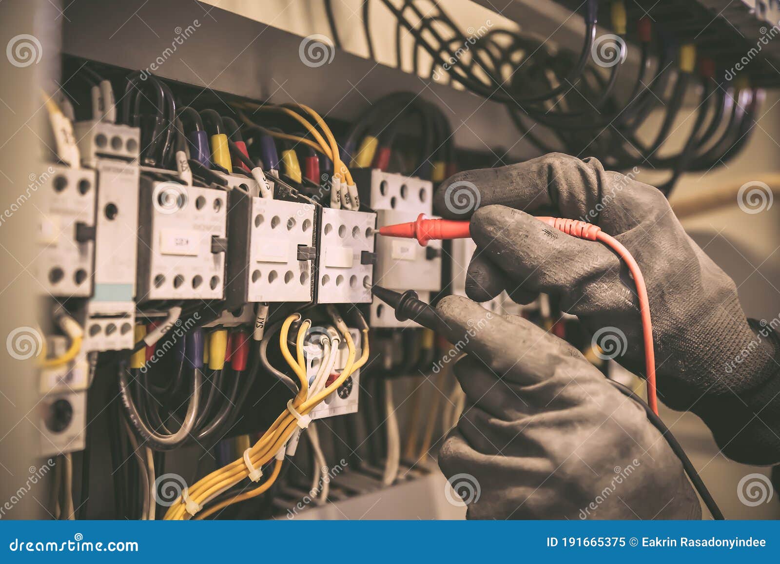 electrical engineer using digital multi-meter measuring equipment to checking electric current voltage at circuit breaker