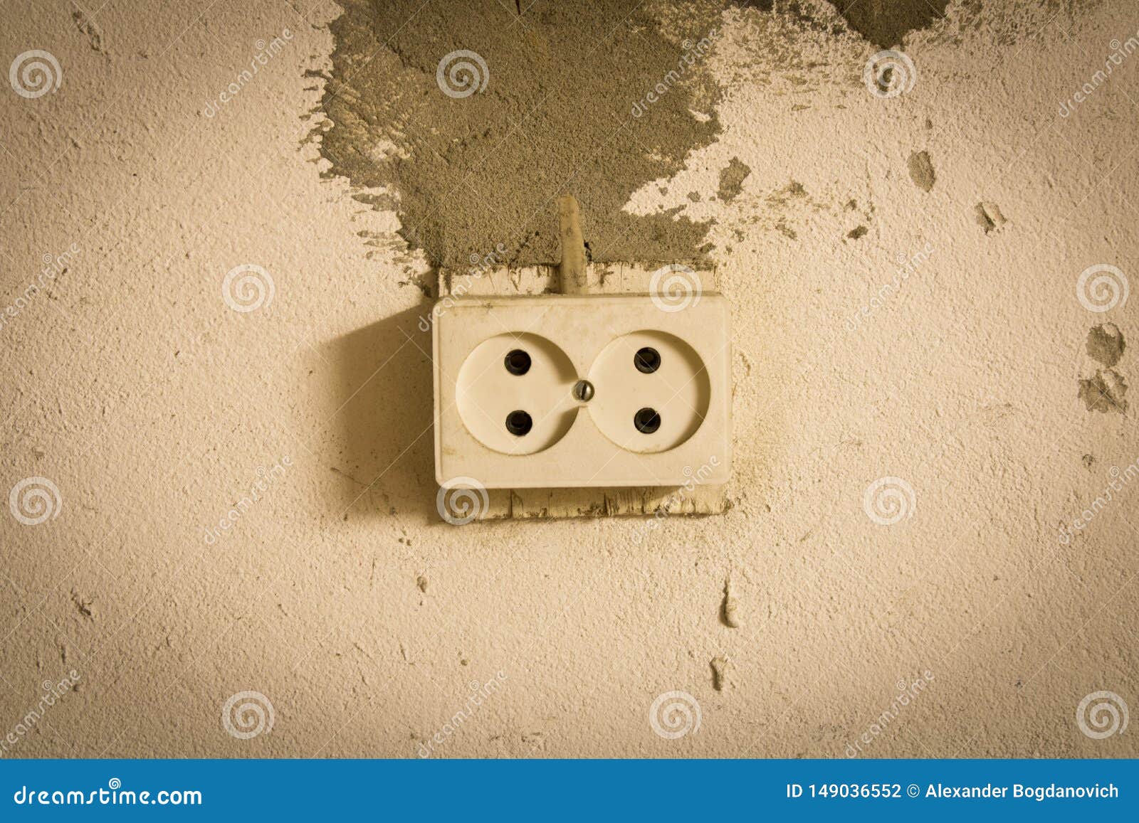 Electrical Outlet on the Old Concrete Wall. Isolated on Light