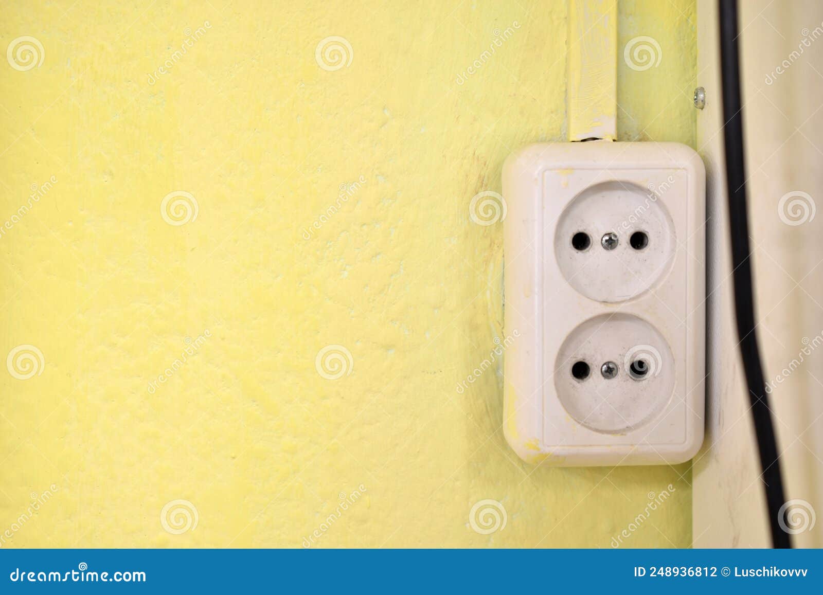 Electrical Outlet on the Yellow Wall in the House Stock Photo Image
