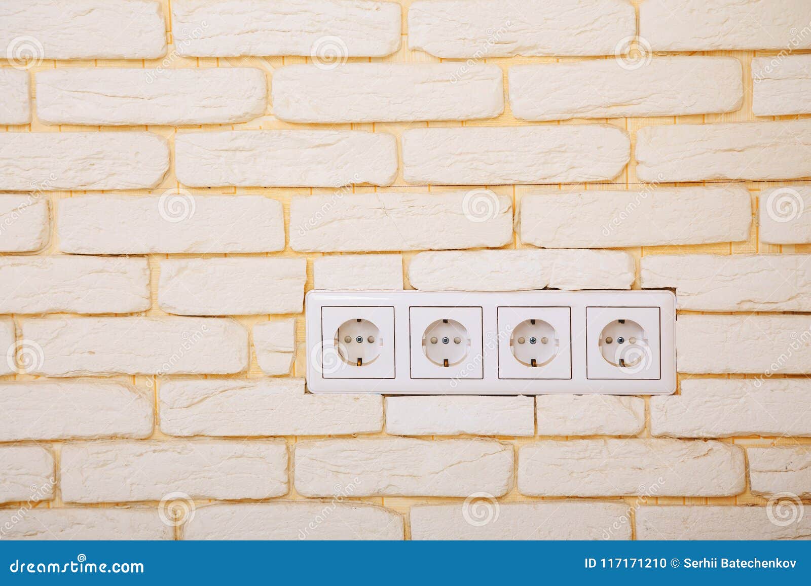 Electrical Outlets or Network Sockets in the Brick Wall Stock Photo