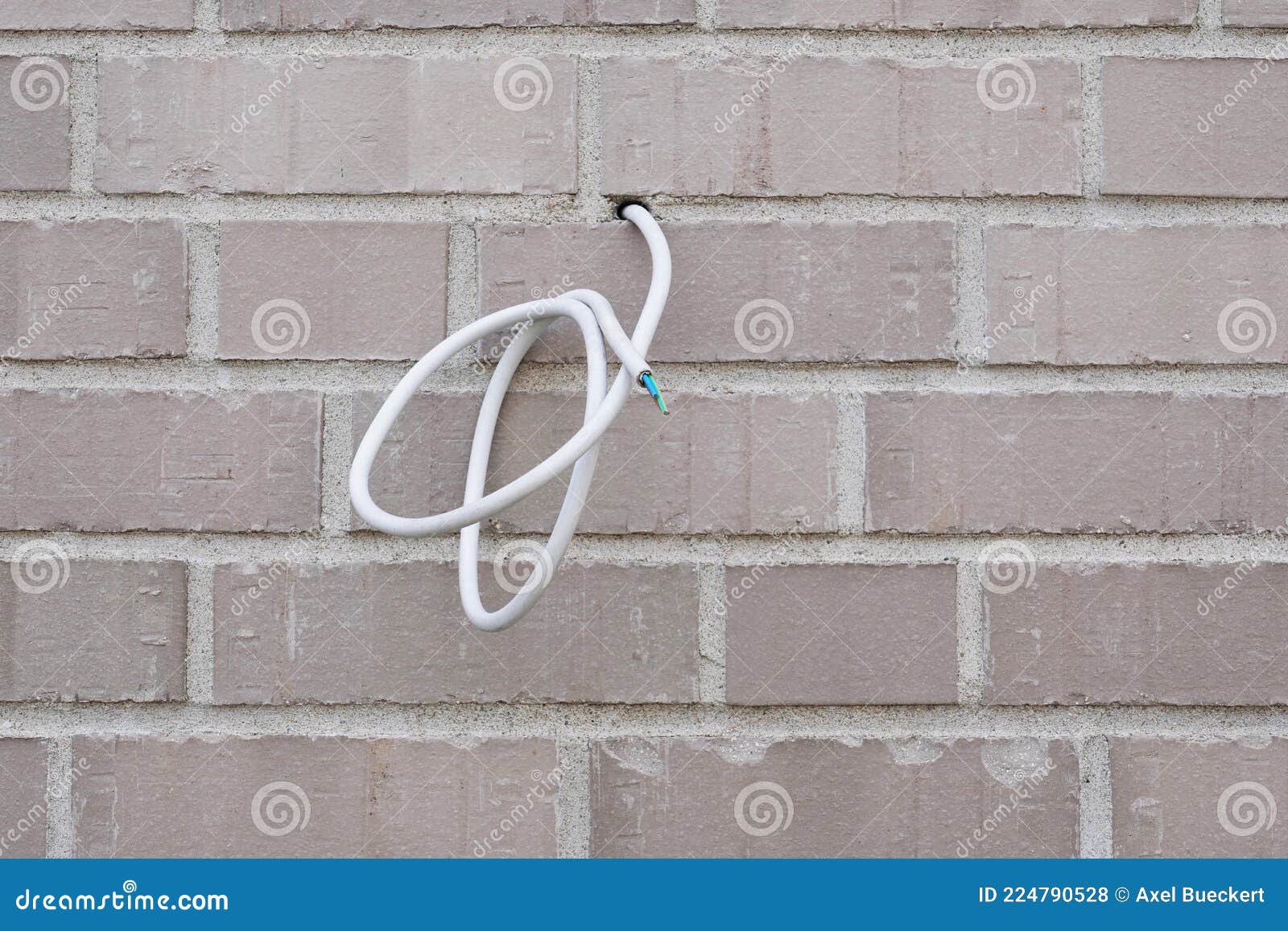 Electrical Wire or Power Cable Hanging from Exterior Wall Stock Photo