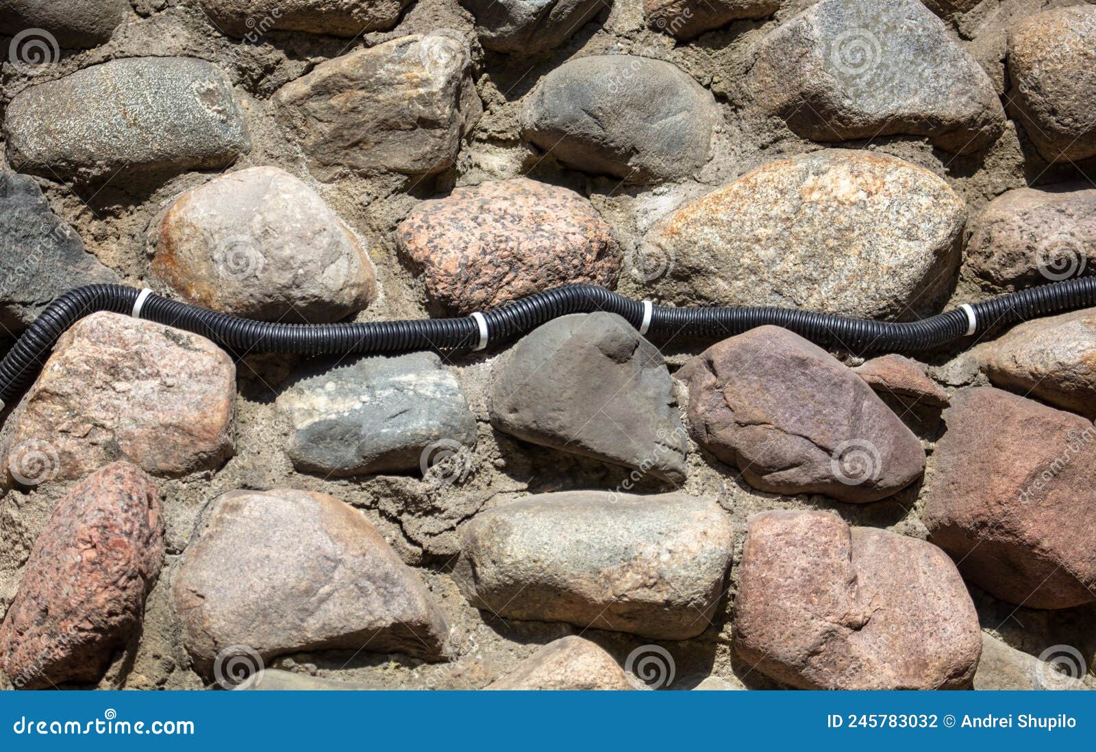 Electrical Wiring on the Wall of Stone Bricks. Stock Photo Image of