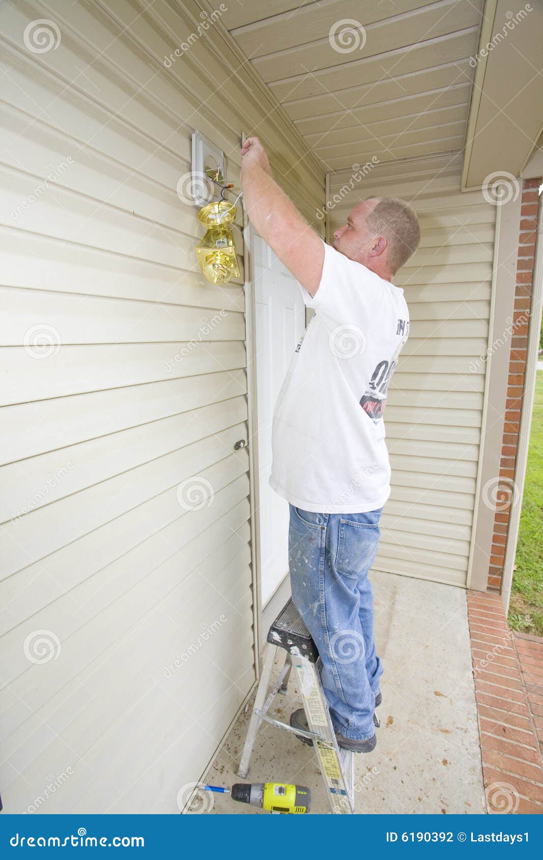 Electrician installing new light fixture