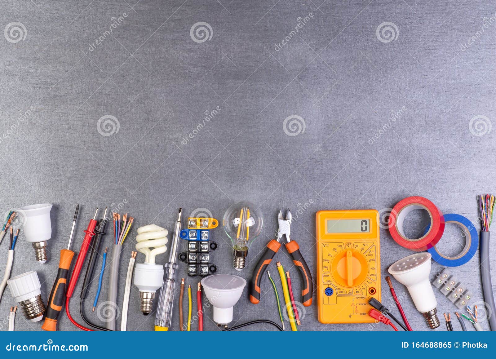 electrician equipment on metalic background, top view