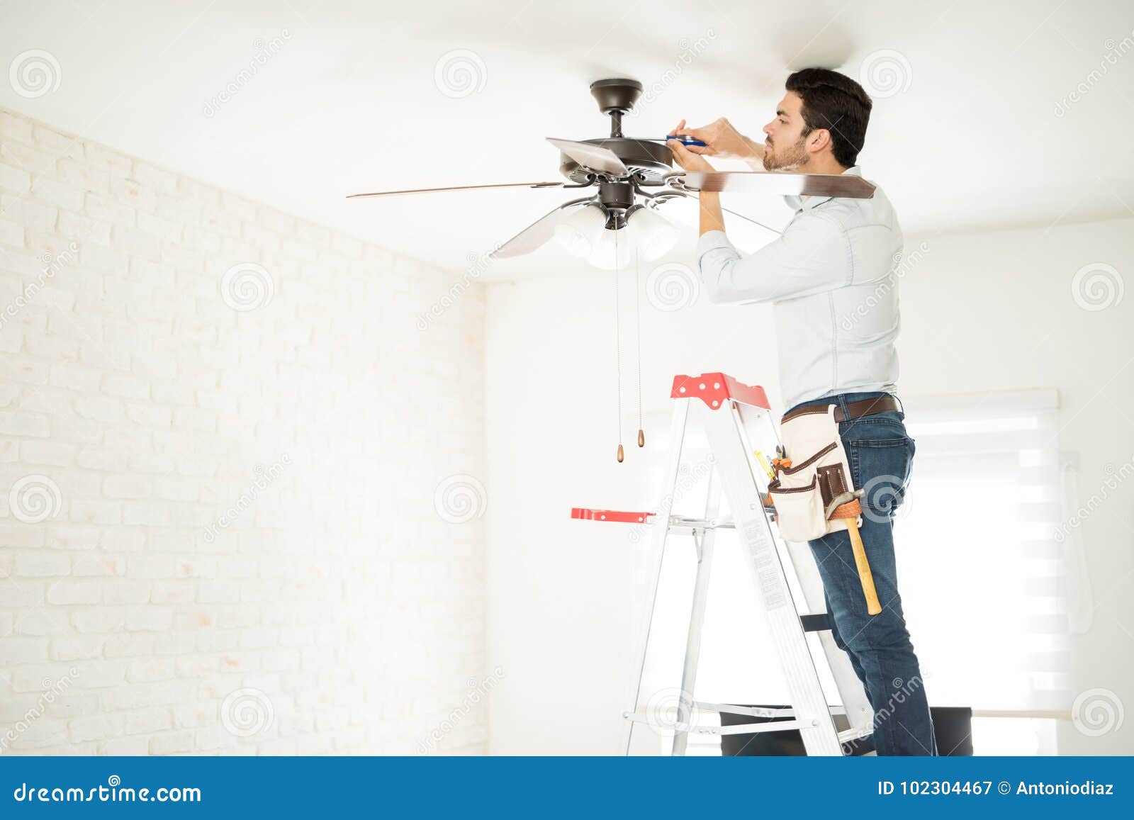 Electrician Fixing A Ceiling Fan Stock Image Image Of Handyman
