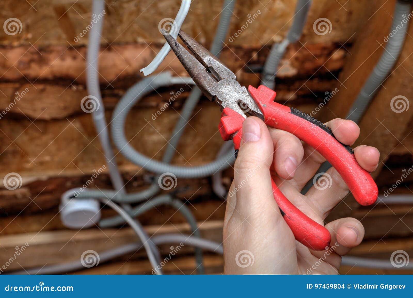 Electrician Hand With Pliers During Install Mount Light Junction