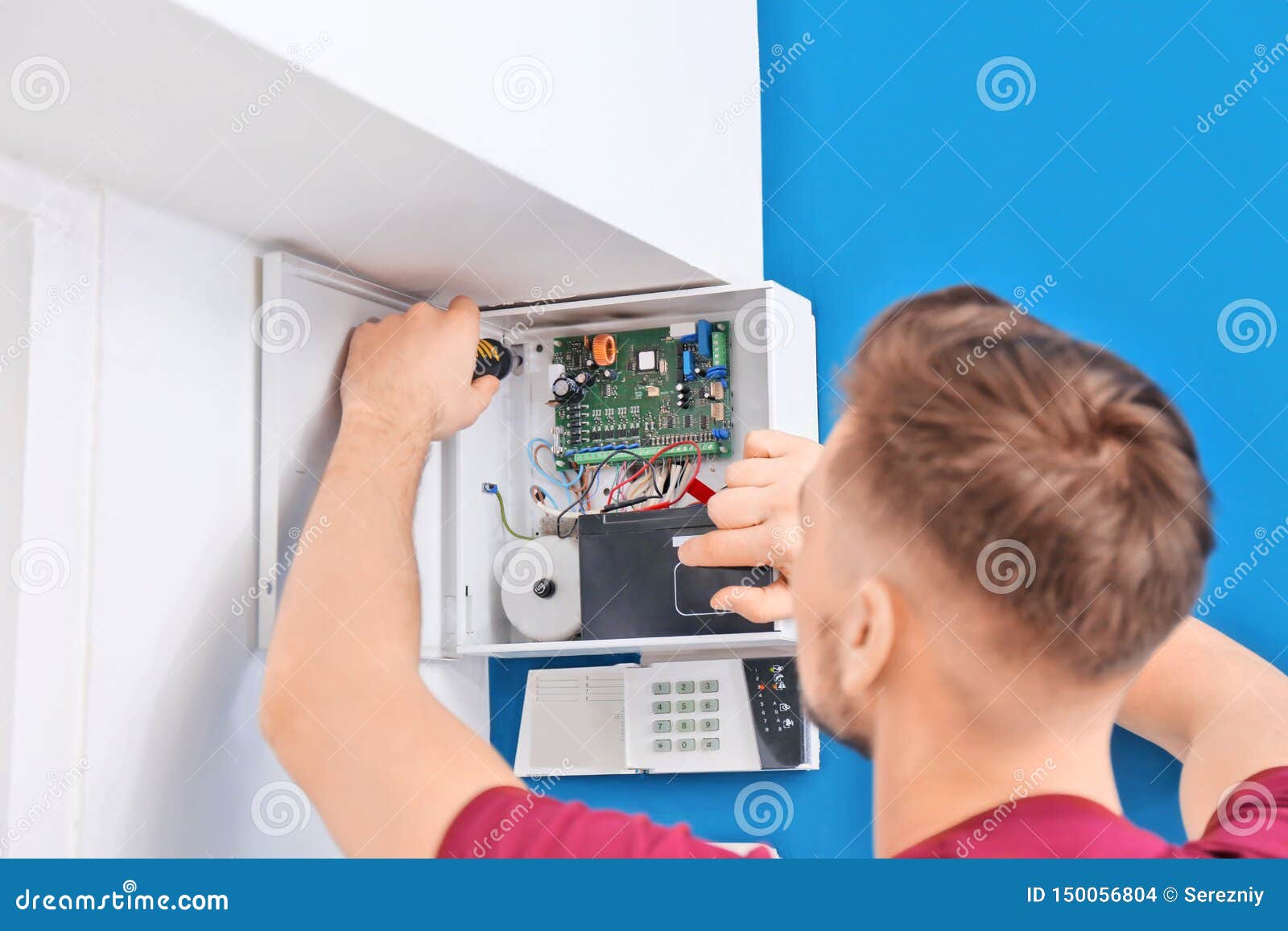 Electrician installing alarm system