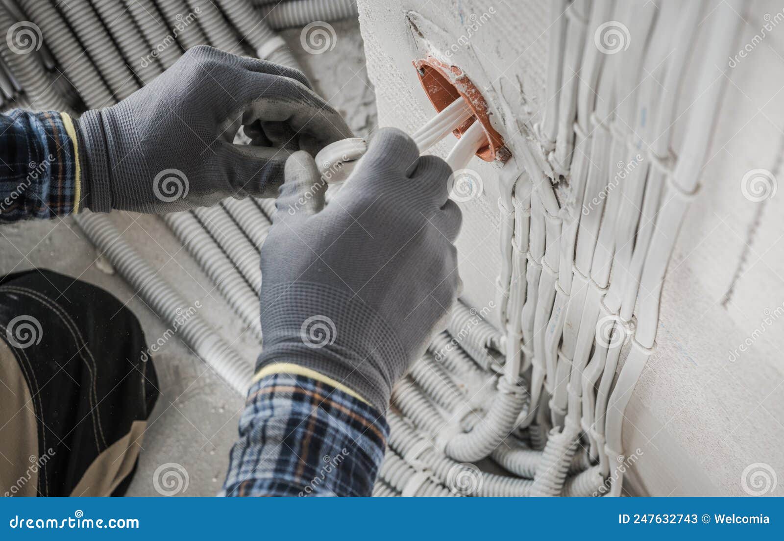 Electrician Installing Electric System Inside a Newly Built House Stock