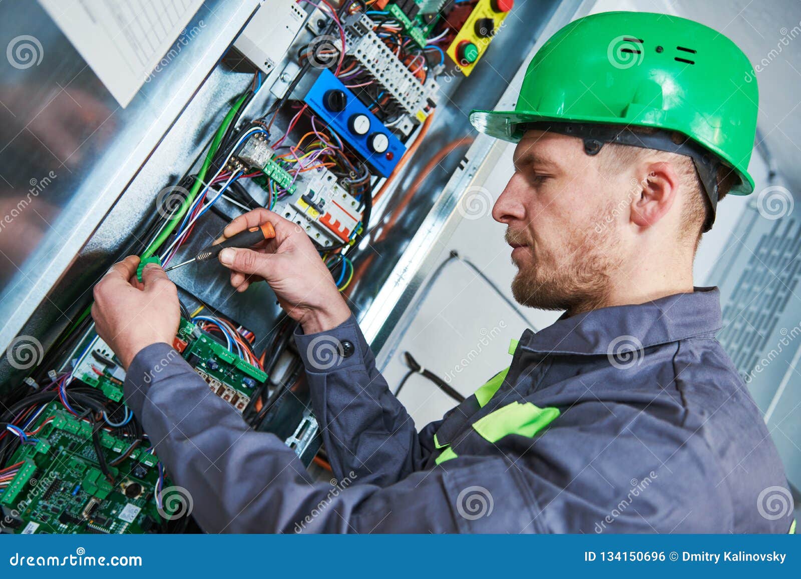 electrician make maintenance in engine room of elevator