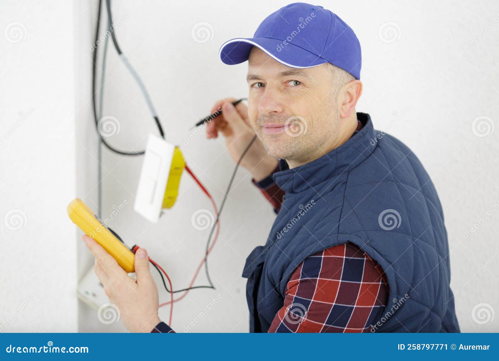 Electrician Measuring Voltage Cable on Ceiling Indoors Stock Image